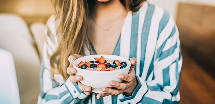 patient eating a healthy cereal after receiving diet guidance from La Verne chiropractor