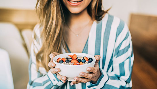 patient eating a healthy cereal after receiving diet guidance from La Verne chiropractor