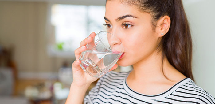 patient drinking water to be healthy under the guidance of La Verne chiropractor