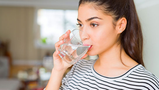 patient drinking water to be healthy under the guidance of La Verne chiropractor