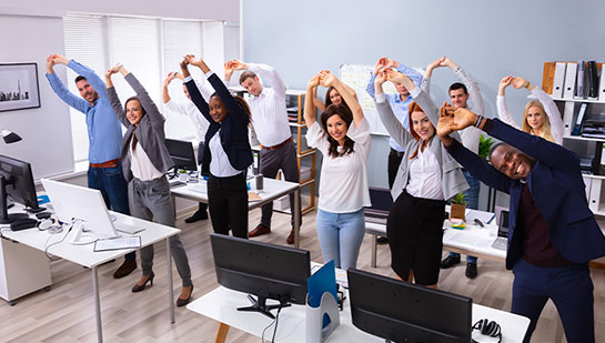 office team stretching together under guidance of La Verne chiropractor